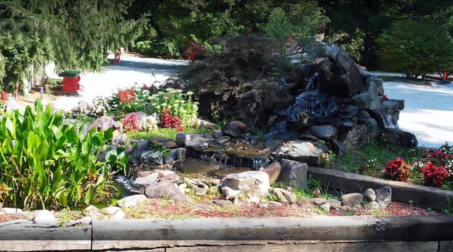 Small decorative waterfall with rocks and plants
